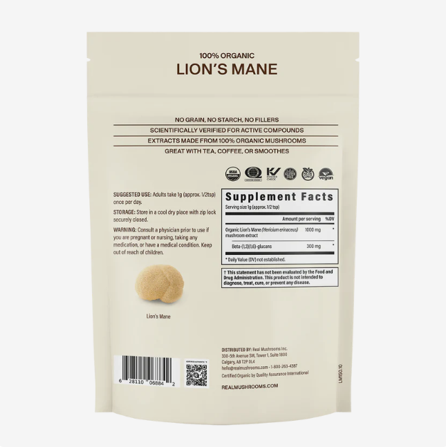 A beige pouch labeled Real Mushrooms Organic Lions Mane Mushroom Powder – 60g displays supplement facts, suggested use, and a small image of the mushroom extract powder on the back of the package. This product is formulated to support natural brain function.