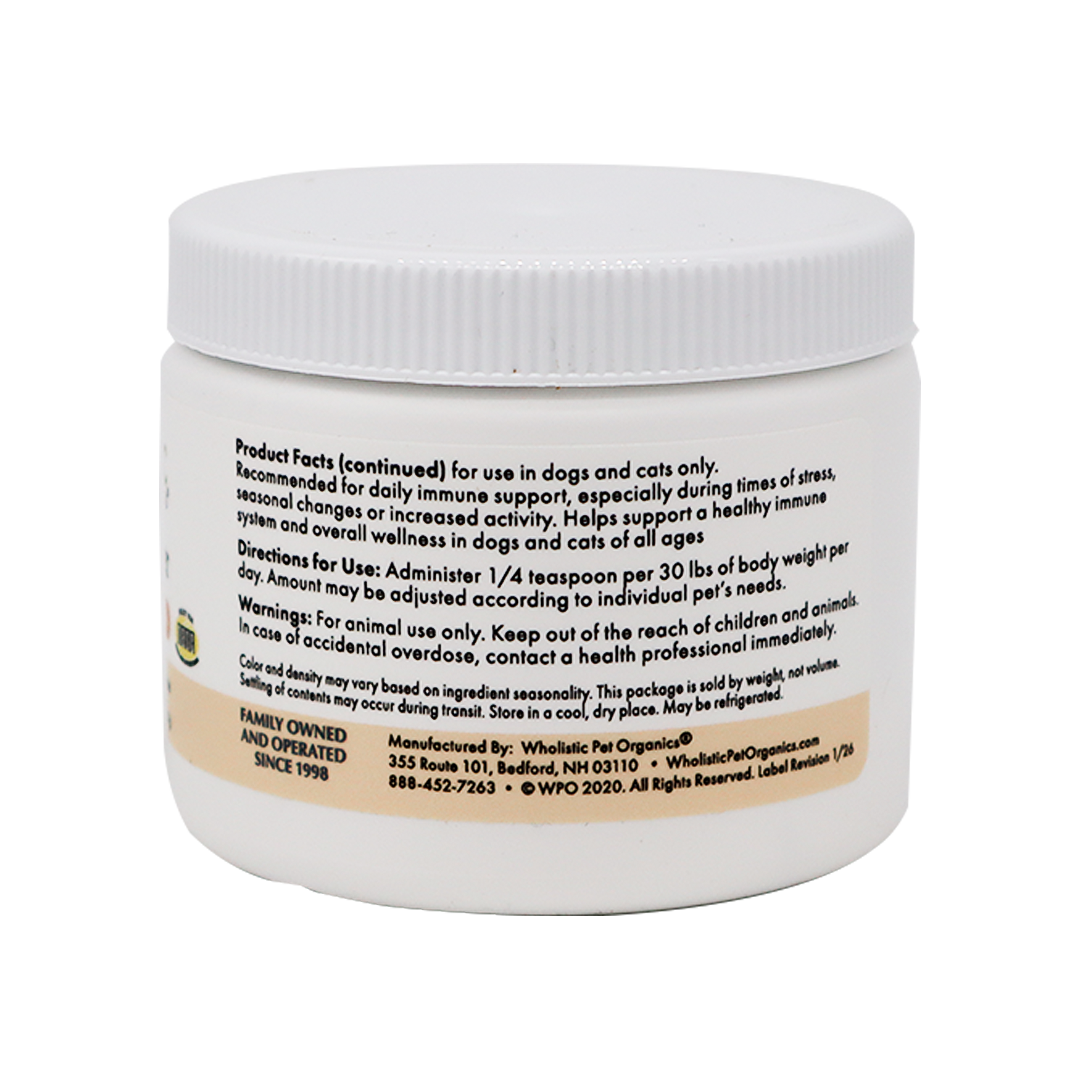 A white plastic container labeled "Wholistic Organics | Immune Boost - Ester-C" contains usage instructions, Vitamin C dosage for dogs and cats, immune support info, and manufacturer contact details.