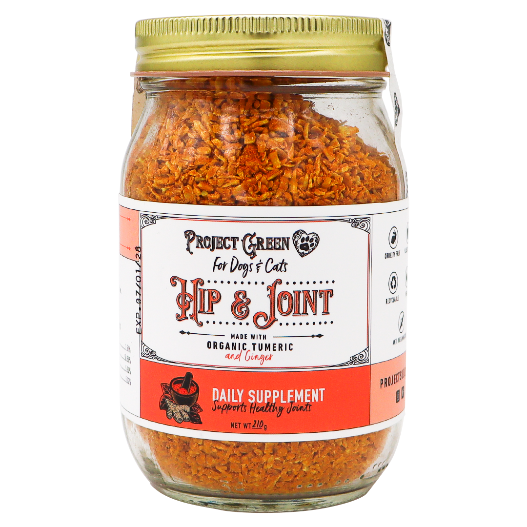 A glass jar with a gold lid containing orange flakes labeled Project Sudz | Hip & Joint Support for Dogs and Cats - 210g, featuring an advanced hip and joint formula with organic turmeric and ginger to support pet mobility.