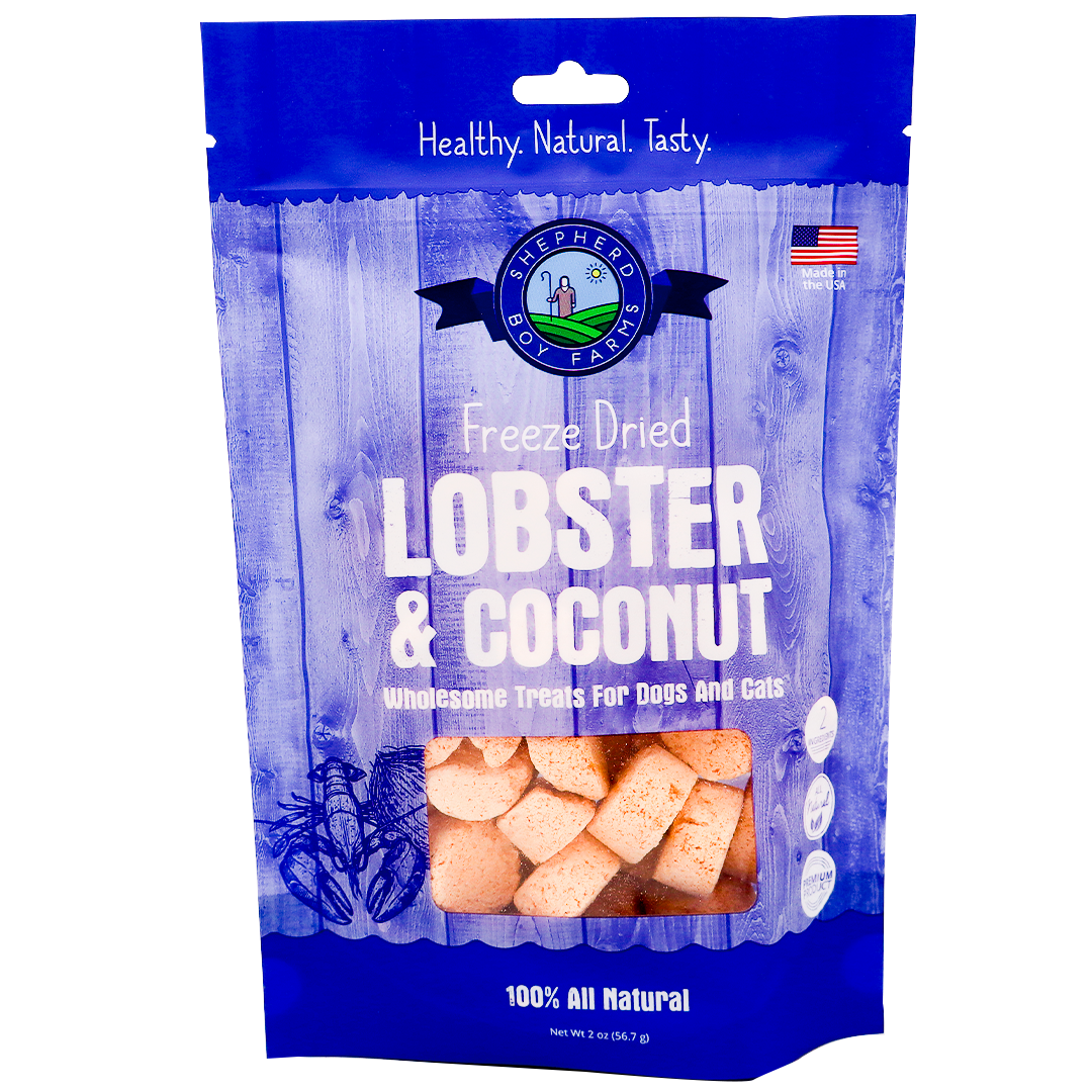 Shepherd Boy Farms | Freeze-Dried Lobster & Coconut Treats - 2oz features chunky lobster and organic coconut for dogs and cats in a blue and white bag. The packaging highlights “Healthy. Natural. Tasty.” and “100% All Natural.”.