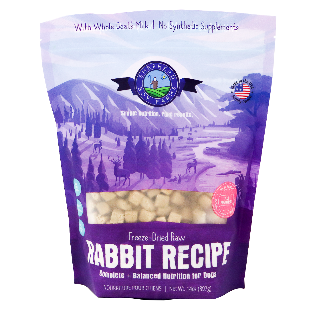 A 14 oz (397g) bag of Shepherd Boy Farms Freeze-Dried Rabbit Recipe for Dogs, featuring a purple design with a nature scene and deer, emphasizes goat’s milk and the absence of synthetic supplements. This high-protein, organic dog food provides wholesome nutrition for your pet.