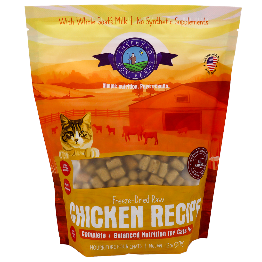 Certainly! Here’s the rewritten sentence using your product data: A 14oz bag of Shepherd Boy Farms Chicken Recipe for Cats showcases a farm-themed background, a playful cat illustration, and text promoting whole goat’s milk and natural ingredients—all combined in a tasty freeze-dried raw chicken recipe your feline will love.