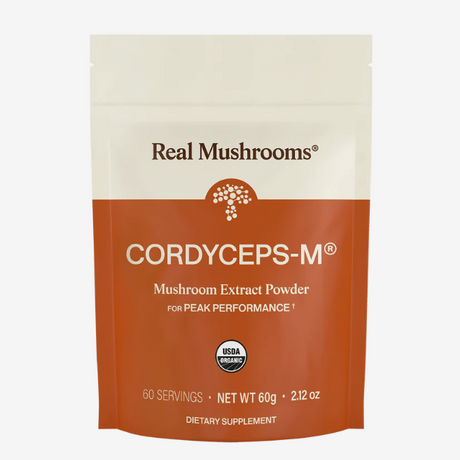 Real Mushrooms | Organic Cordyceps Mushroom Powder – 60g features USDA organic mushroom powder rich in beta-glucans, providing 60 servings in a white and orange package, designed as a dietary supplement for peak performance.