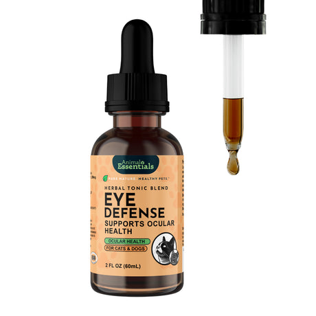 A brown glass dropper bottle labeled “Animal Essentials | Eye Defense Herbal Tonic Blend - 2oz” for cats and dogs, with a dropper releasing liquid beside it. The beige label features green and black text along with pet illustrations, emphasizing enhanced ocular comfort and defense for pets.