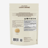 A beige pouch labeled Real Mushrooms Organic Lions Mane Mushroom Powder – 60g displays supplement facts, suggested use, and a small image of the mushroom extract powder on the back of the package. This product is formulated to support natural brain function.
