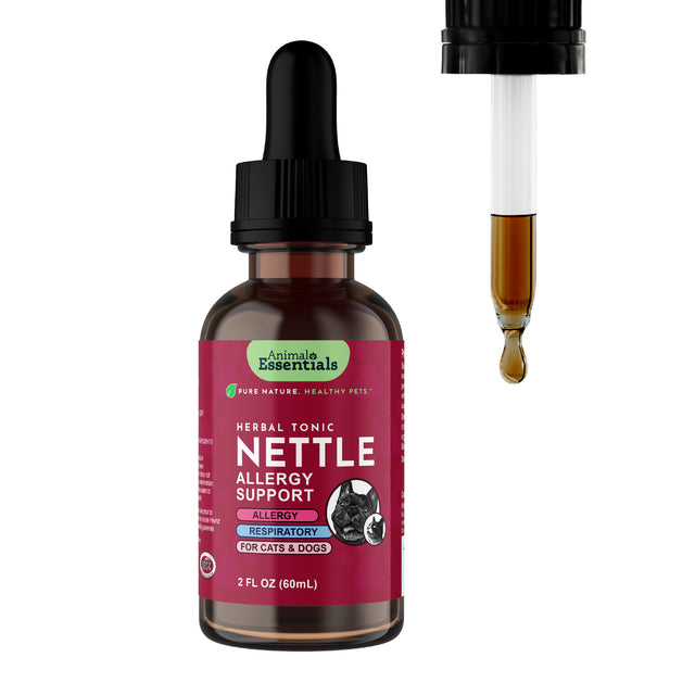 A brown glass dropper bottle labeled Animal Essentials | Nettle Herbal Tonic - 2oz, with a dropper dispensing a drop of amber liquid alongside it—offering an organic nettle supplement for gentle herbal wellness and effective allergy support for pets.