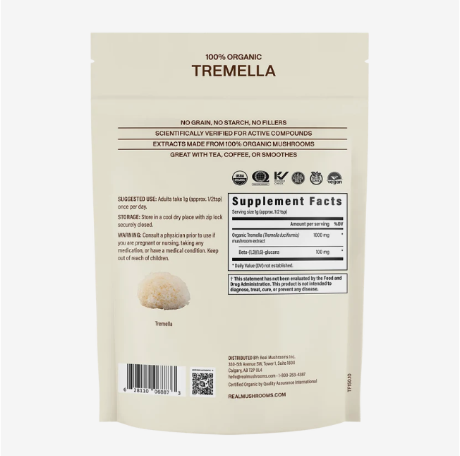 Back view of a beige Real Mushrooms | Organic Tremella Extract Powder – 60g pouch, displaying supplement facts, suggested use, warning, and product details. The pouch features the inclusion of organic Tremella mushroom extract standardized for beta-glucans, with a small image of Tremella mushrooms at the bottom left.