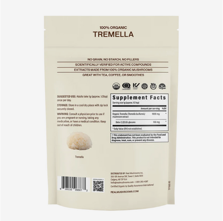 Back view of a beige Real Mushrooms | Organic Tremella Extract Powder – 60g pouch, displaying supplement facts, suggested use, warning, and product details. The pouch features the inclusion of organic Tremella mushroom extract standardized for beta-glucans, with a small image of Tremella mushrooms at the bottom left.