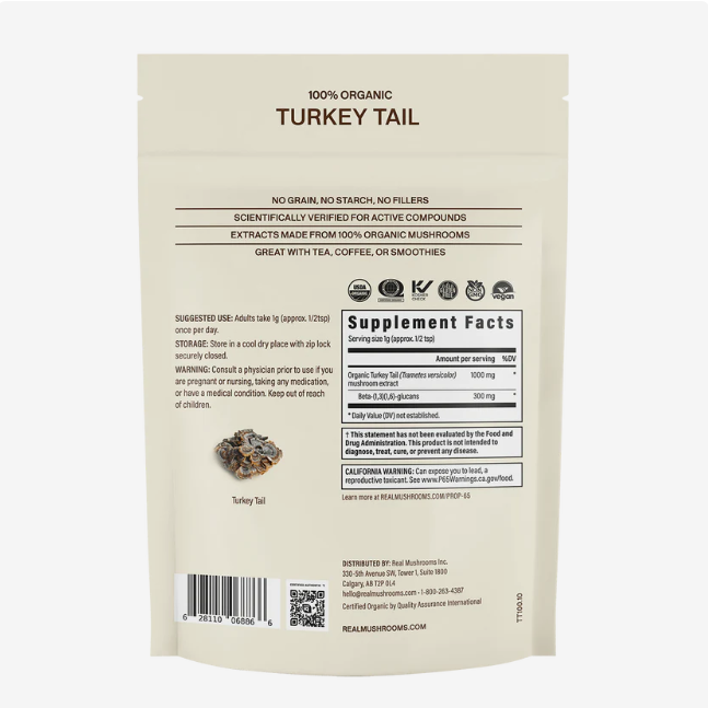 Back of a Real Mushrooms | Organic Turkey Tail Extract Powder - 45g bag displaying suggested use, warnings, supplement facts, and key product features. The text emphasizes that it is made with 100% organic turkey tail mushroom powder and contains beta-glucans. Ideal for mixing into tea, coffee, or smoothies.