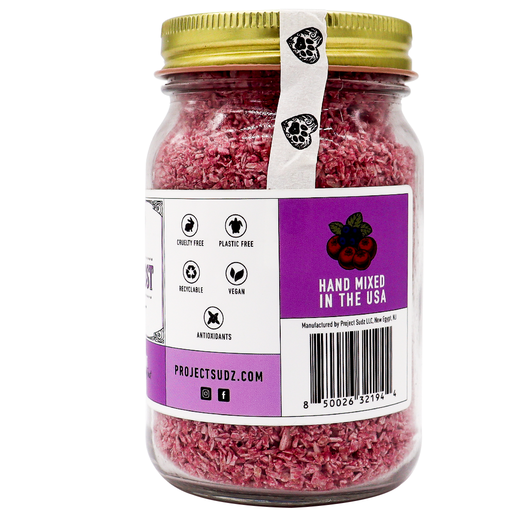Project Sudz | Berry Boost Urinary Support for Dogs and Cats – 210g comes in a glass jar with a gold lid, containing pink bath soak infused with nourishing cranberry and other botanical ingredients. The labels indicate it’s cruelty-free, plastic-free, vegan, rich in antioxidants, hand-mixed in the USA, and feature the website projectsudz.com.