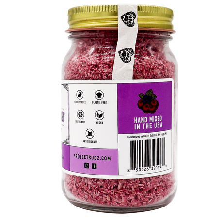 Project Sudz | Berry Boost Urinary Support for Dogs and Cats – 210g comes in a glass jar with a gold lid, containing pink bath soak infused with nourishing cranberry and other botanical ingredients. The labels indicate it’s cruelty-free, plastic-free, vegan, rich in antioxidants, hand-mixed in the USA, and feature the website projectsudz.com.