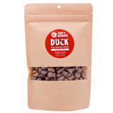 A brown resealable bag labeled Woof Creek Freeze-Dried Raw Duck Rewards | 2oz Pouch for Dogs + Cats, featuring visible brown treat pieces inside through a clear window. Perfect as high-value training rewards, these duck treats are irresistible for both dogs and cats.