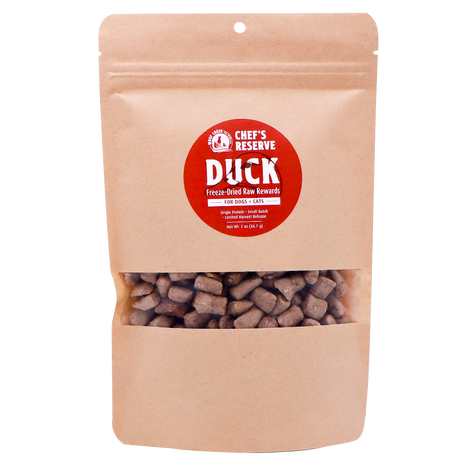 A brown resealable bag labeled Woof Creek Freeze-Dried Raw Duck Rewards | 2oz Pouch for Dogs + Cats, featuring visible brown treat pieces inside through a clear window. Perfect as high-value training rewards, these duck treats are irresistible for both dogs and cats.