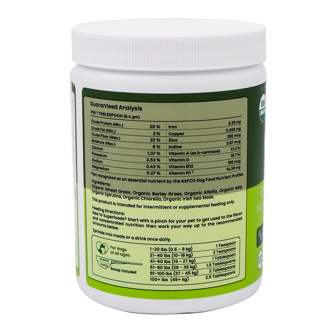 White plastic tub of Dog Greens- Organic and Wild Harvested Vitamin and Mineral Supplement for Dogs, showing the guaranteed analysis, ingredient list, and feeding chart on the label for this plant-based vitamin and mineral blend.