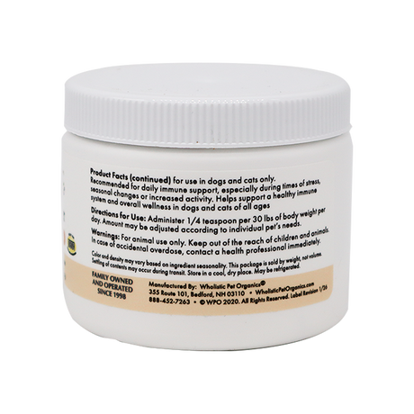 A white plastic container labeled "Wholistic Organics | Immune Boost - Ester-C" contains usage instructions, Vitamin C dosage for dogs and cats, immune support info, and manufacturer contact details.