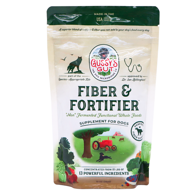 A beige 10oz bag of Gussy’s Gut | Fiber & Fortifier for Dogs features illustrations of a cat, dog, tractor, vegetables, and a farm scene. The packaging highlights its whole-food fiber blend and describes its benefits as a natural fiber supplement supporting optimal gut health in dogs.
