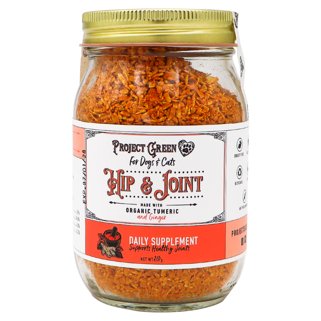 A glass jar with a gold lid containing orange flakes labeled Project Sudz | Hip & Joint Support for Dogs and Cats - 210g, featuring an advanced hip and joint formula with organic turmeric and ginger to support pet mobility.
