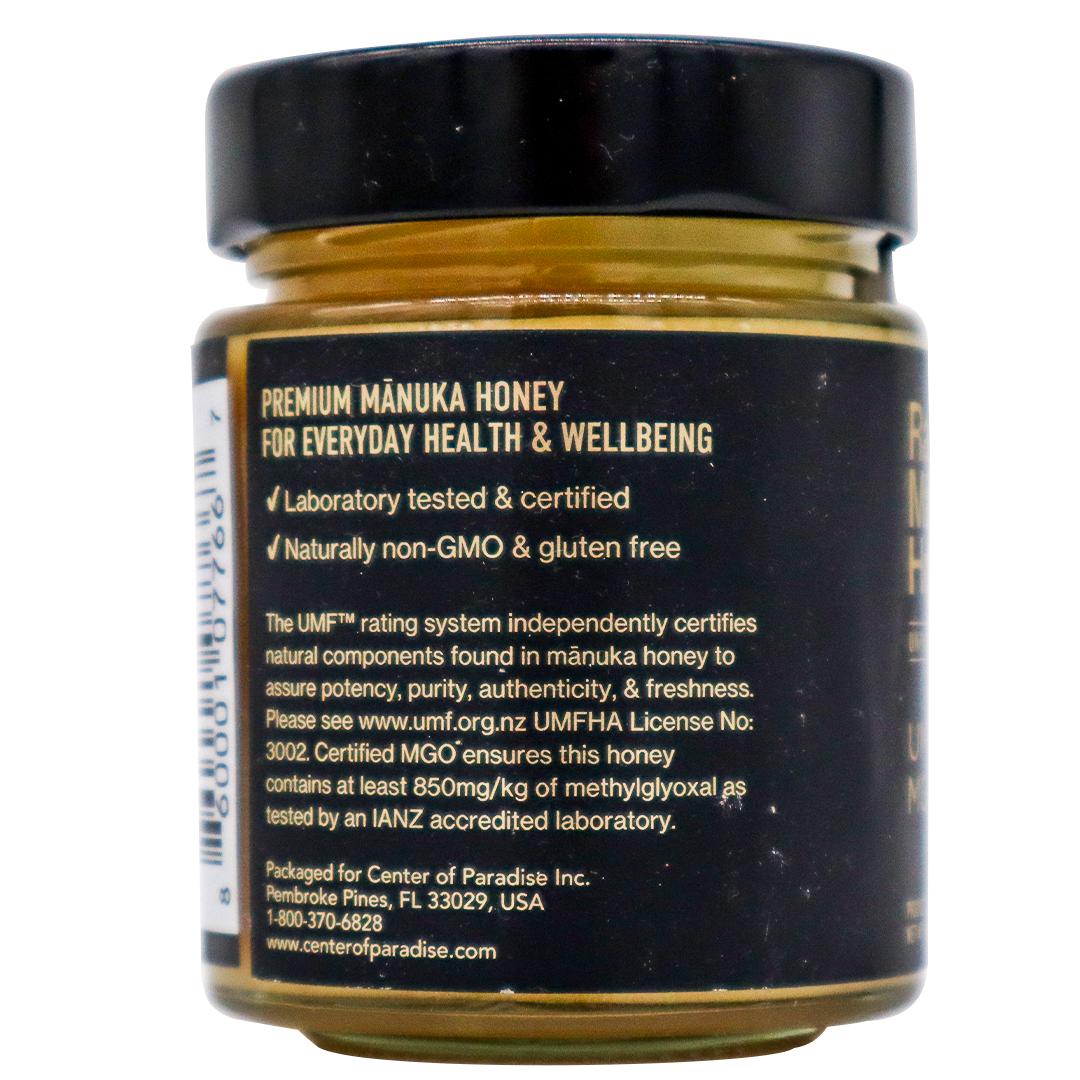 Back label of a Center of Paradise | RAW MANUKA HONEY UMF 20+ MGO 850+ jar detailing its laboratory certification, non-GMO and gluten-free status, MGO 850+ content, and UMF rating information.