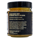 Back label of a Center of Paradise | RAW MANUKA HONEY UMF 20+ MGO 850+ jar detailing its laboratory certification, non-GMO and gluten-free status, MGO 850+ content, and UMF rating information.