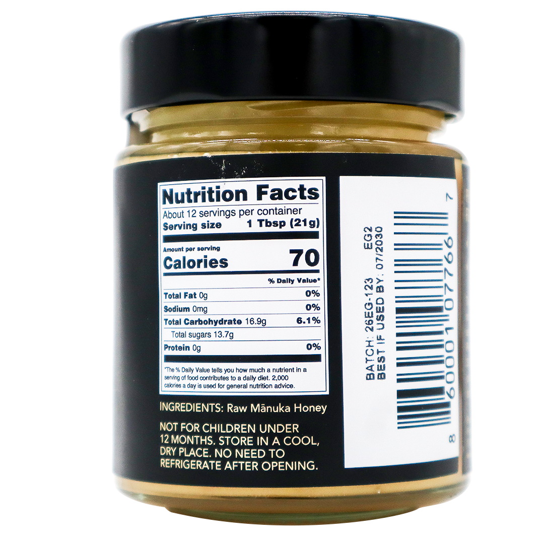 A close-up of a Center of Paradise | RAW MANUKA HONEY UMF 20+ MGO 850+ jar label showing Nutrition Facts, including 70 calories per serving, the ingredients list, and a barcode.