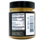 A close-up of a Center of Paradise | RAW MANUKA HONEY UMF 20+ MGO 850+ jar label showing Nutrition Facts, including 70 calories per serving, the ingredients list, and a barcode.