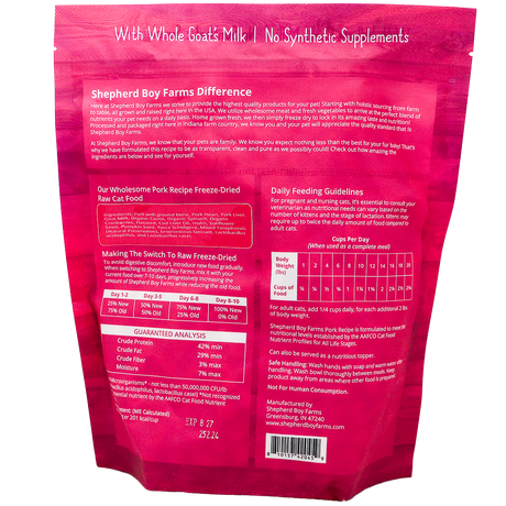 Back of a pink Shepherd Boy Farms | Pork Recipe for Cats - 14oz package displaying feeding guidelines, product description, ingredients list, guaranteed analysis, and contact information. The text highlights the use of whole goat's milk and the absence of synthetic supplements, emphasizing a grain-free cat food formula that supports natural nutrition.