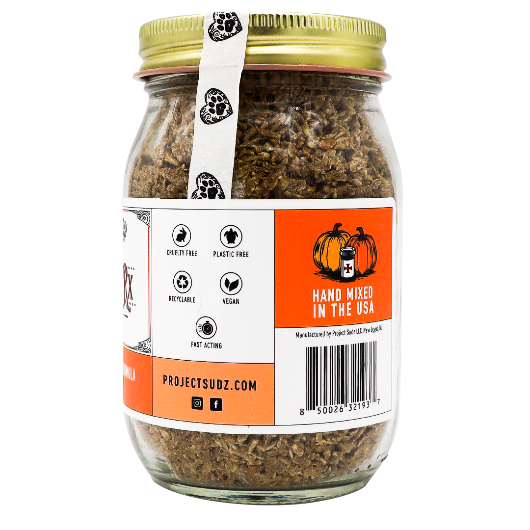 Project Sudz | Pumpkin Rx GI Support for Dogs - 220g comes in a glass jar with a gold lid, filled with brown granules. The label showcases that the product is plastic-free, vegan, recyclable, cruelty-free, and hand mixed in the USA. Featuring a pumpkin graphic and website information, this blend offers healthy gut support—making it an ideal choice for those looking for gentle pumpkin digestive relief for dogs made with care.