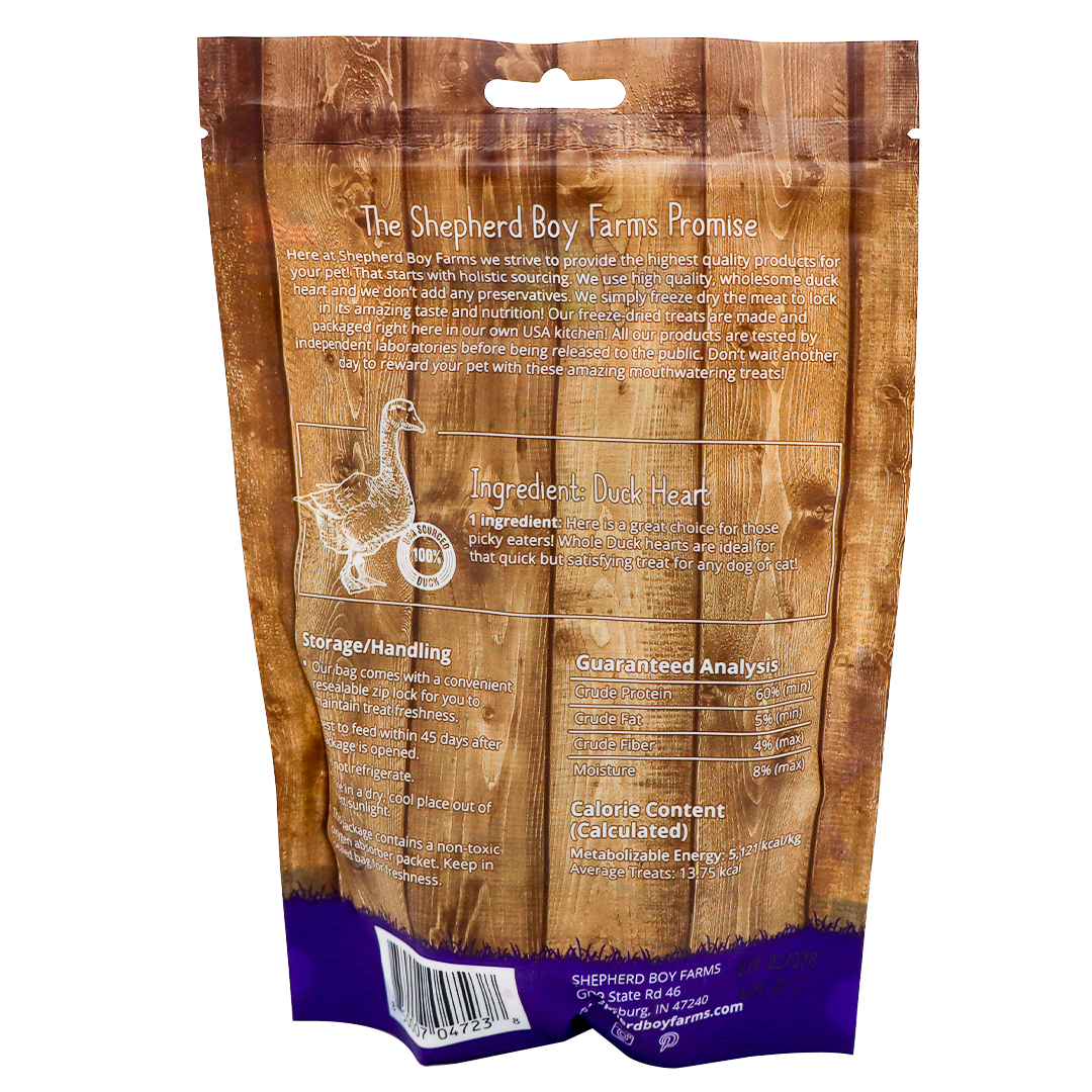 The back of the Shepherd Boy Farms Freeze-Dried Duck Hearts - 3oz bag displays a brand promise, high protein duck heart details, storage instructions, guaranteed analysis, calorie info, contact details, and features a wood-plank design.