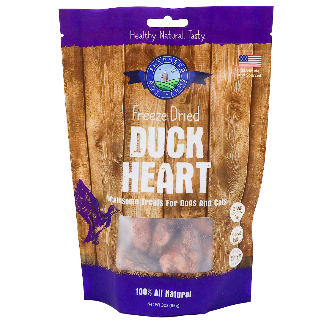 A 3oz bag of Shepherd Boy Farms Freeze-Dried Duck Hearts—single-ingredient, 100% all natural treats for dogs and cats—with a wood-grain design, product name, and a small window displaying the freeze-dried duck hearts inside.