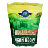 A green and yellow bag of Shepherd Boy Farms Freeze-Dried Bison Recipe (14oz) dog food, featuring a natural landscape with animals and trees. This grain-free recipe includes goat’s milk, no synthetic supplements, and is AAFCO approved.