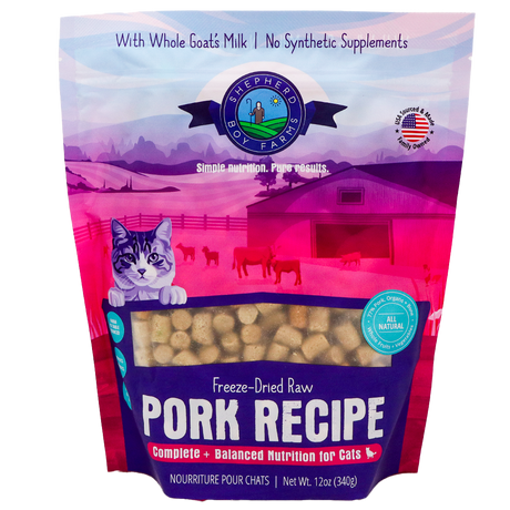 A 14 oz (396 g) bag of Shepherd Boy Farms Pork Recipe for Cats features freeze-dried raw pork, a cartoon cat with a farm background, and text highlighting goat's milk and balanced nutrition for cats. This grain-free cat food provides wholesome nourishment in every serving.