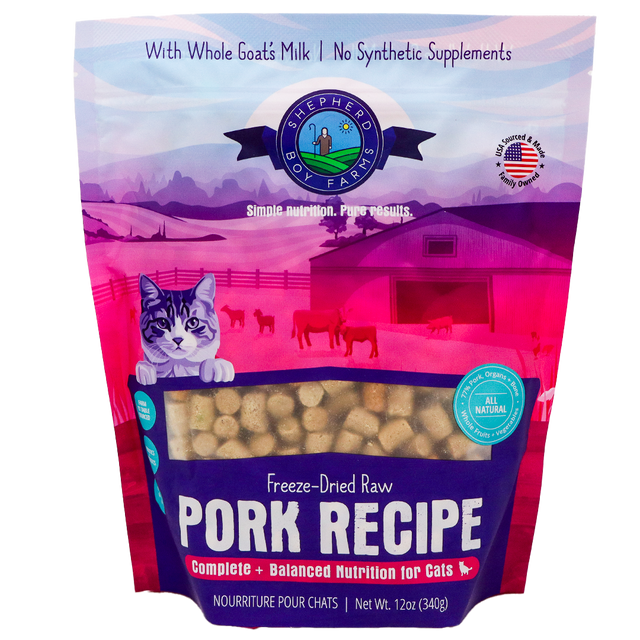 A 14 oz (396 g) bag of Shepherd Boy Farms Pork Recipe for Cats features freeze-dried raw pork, a cartoon cat with a farm background, and text highlighting goat's milk and balanced nutrition for cats. This grain-free cat food provides wholesome nourishment in every serving.
