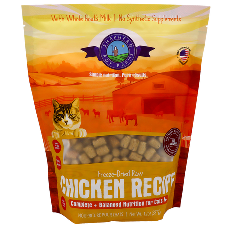 Certainly! Here’s the rewritten sentence using your product data: A 14oz bag of Shepherd Boy Farms Chicken Recipe for Cats showcases a farm-themed background, a playful cat illustration, and text promoting whole goat’s milk and natural ingredients—all combined in a tasty freeze-dried raw chicken recipe your feline will love.