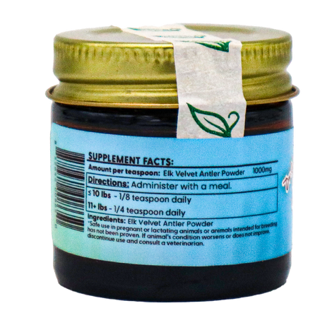 A small jar labeled "Dr. Judy's Elk Velvet Antler Powder for Cats - 7g" features a gold lid and a blue label displaying supplement facts, directions for use, and ingredients for this all-natural source of IGF-1, designed to help support your cat’s joints.