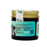 A small amber jar of Dr. Judy's Elk Velvet Antler Powder for Small Dogs (7g) with a gold lid and a blue label displaying information about pet health benefits such as joint support for dogs, as well as a barcode and a photo of two dogs. A white seal with a green leaf design runs across the lid.