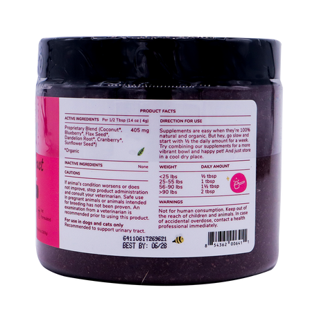 A close-up of the kin+kind Urinary Tract with Antioxidant Boost supplement jar label displays product facts, directions, active and inactive ingredients, a dosage chart by pet weight, caution statements, a barcode, and an expiration date. The jar is black with a white and pink label. Prominently featured on the label are USDA organic superfood supplements formulated for pets to support optimal urinary tract health.